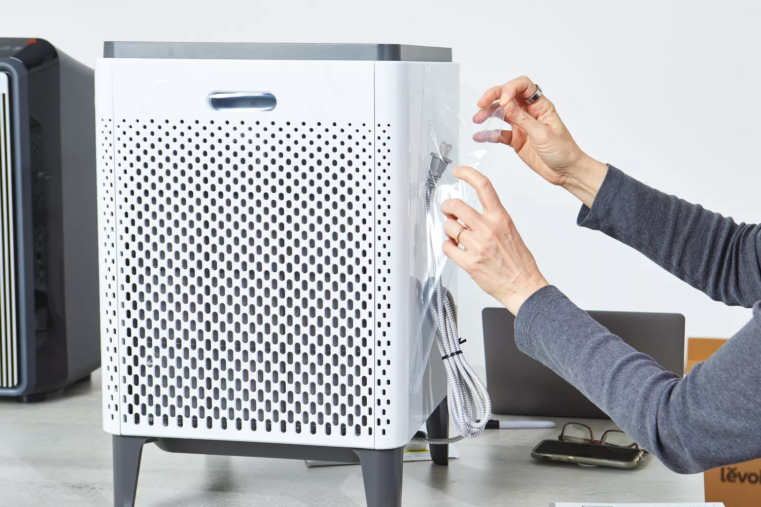 Person unwrapping Coway Airmega 400S Smart Air Purifier