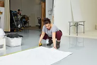 Person using measuring tape on a white Boll & Branch Signature Hemmed Sheet Set