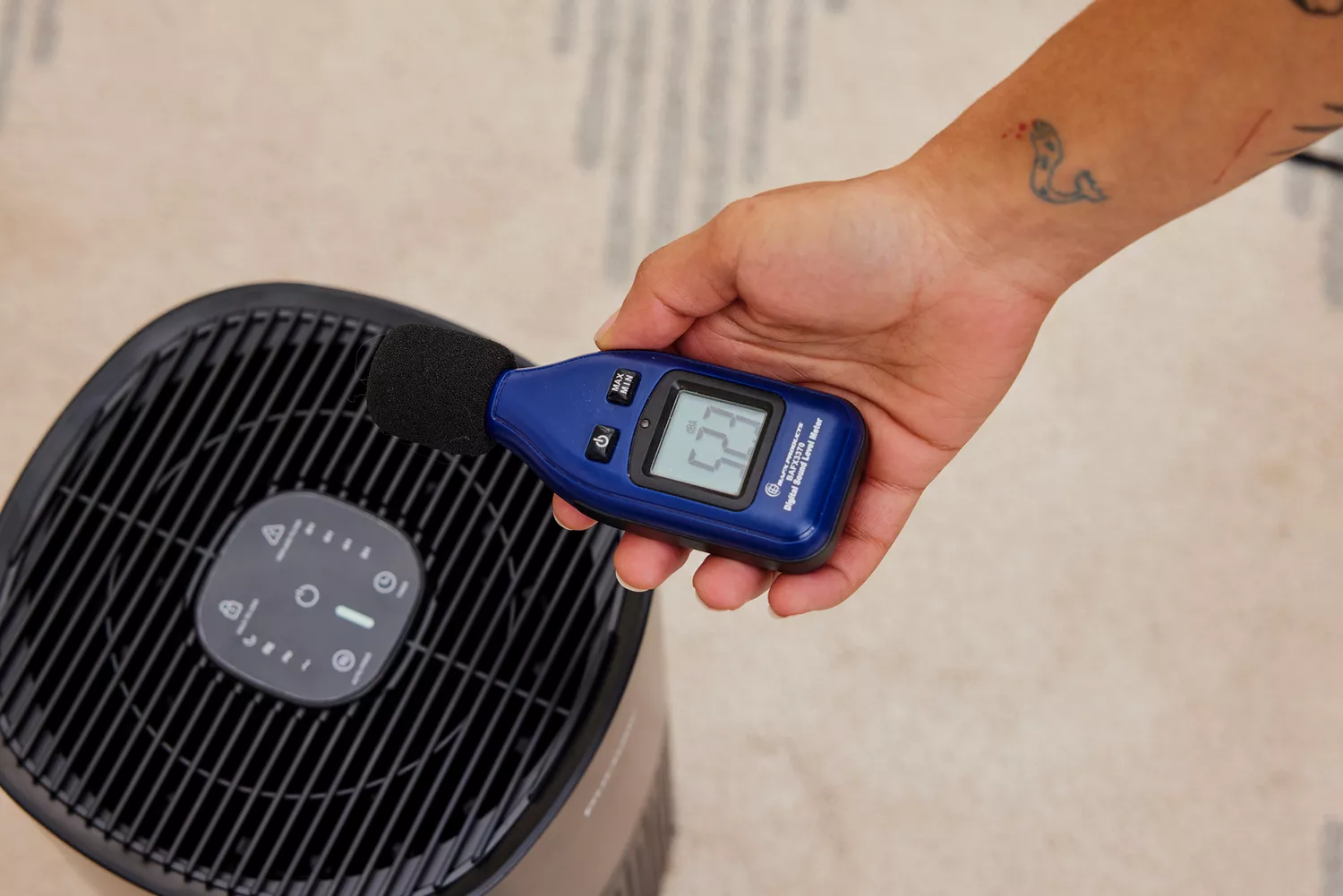 A person measures the noise from the Puroair 240 Air Purifier