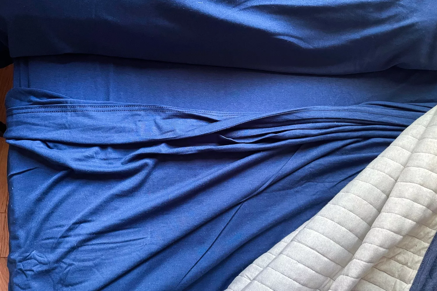 The Better Homes & Gardens 4-Piece Jersey Sheet Set on a bed
