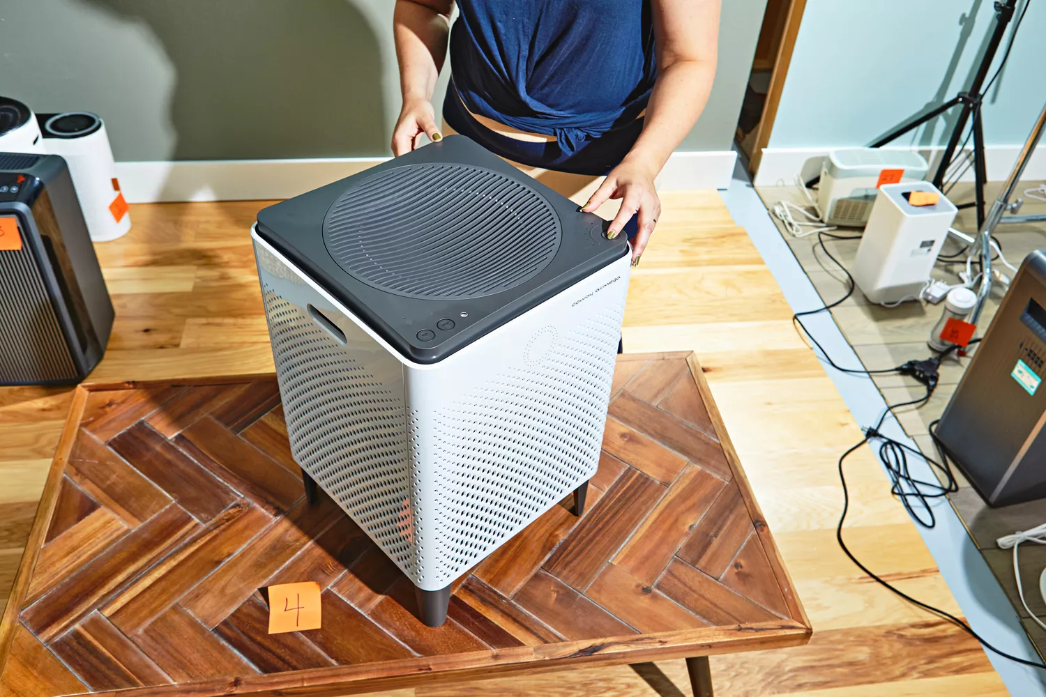 Person pressing a button on Coway Airmega 400S Smart Air Purifier