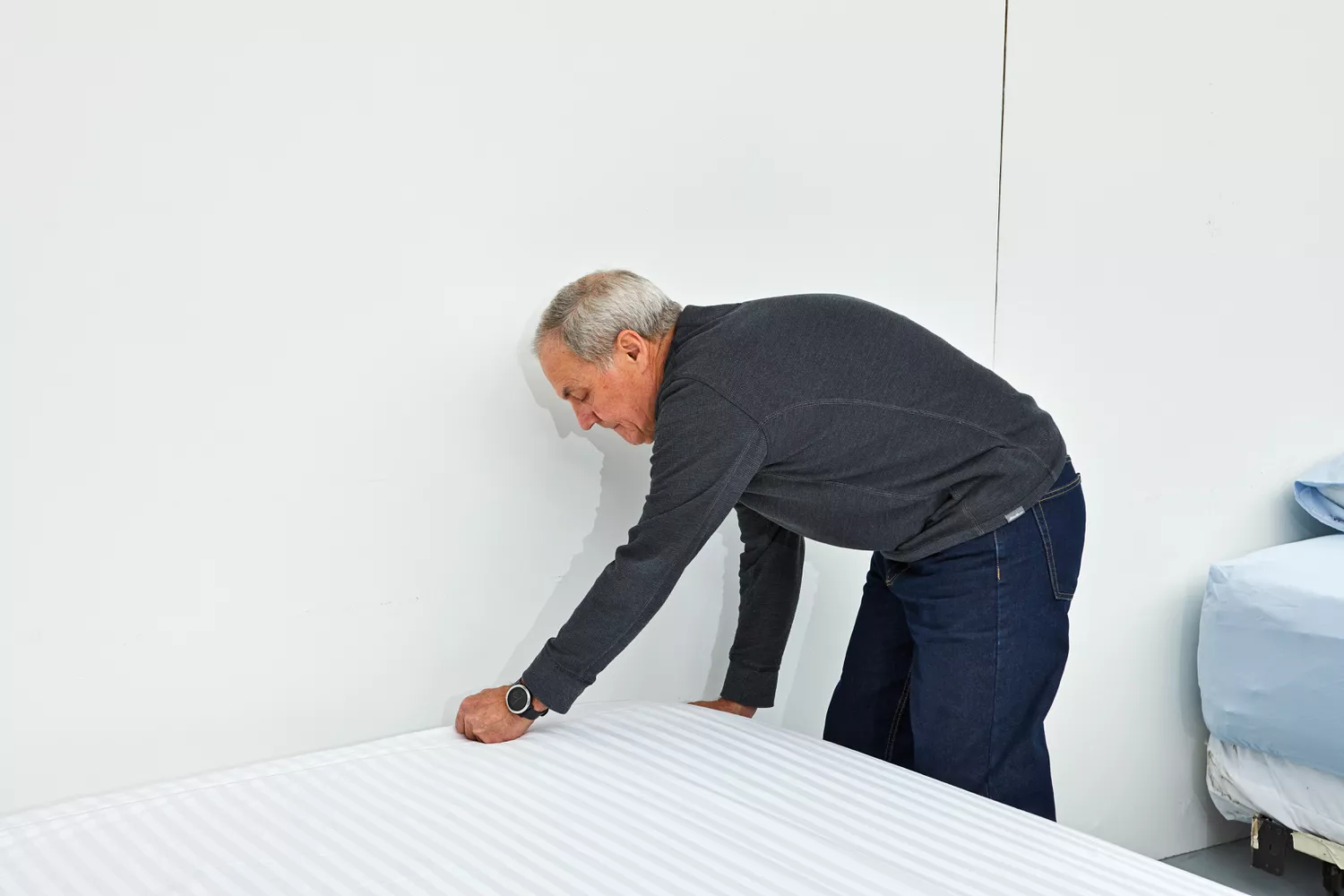 Person tucking the Chateau Home Collection Egyptian Cotton Sheet on a mattress