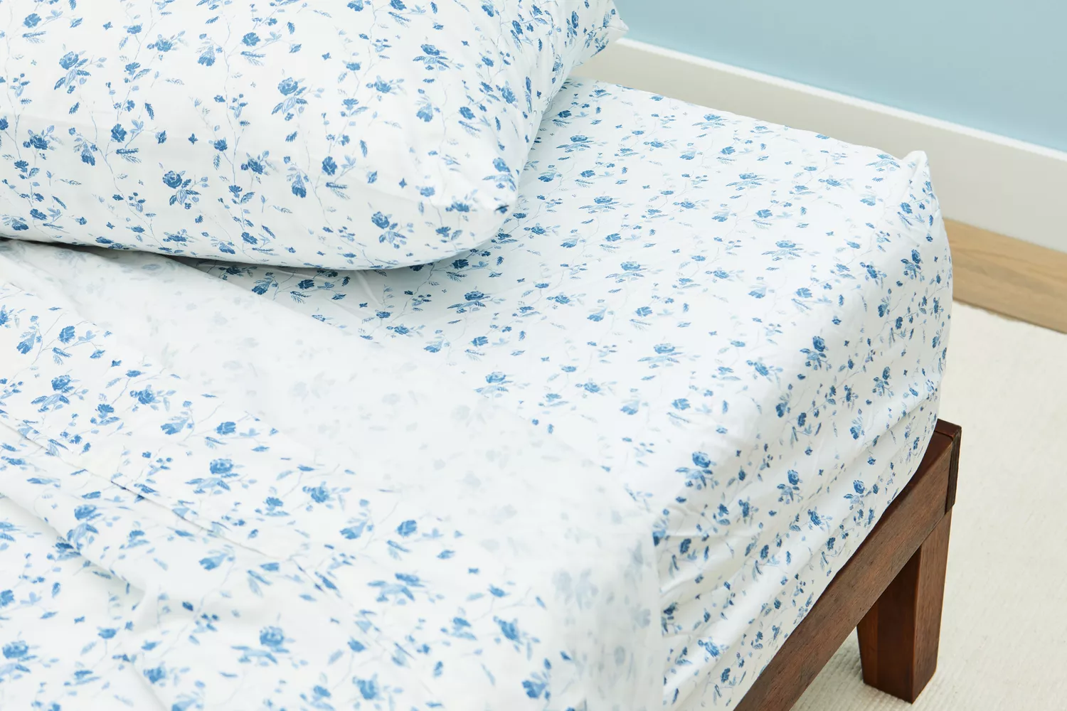 Closeup of the corner of a bed covered with sheets from the Threshold 400 Thread Count Printed Performance Sheet Set 