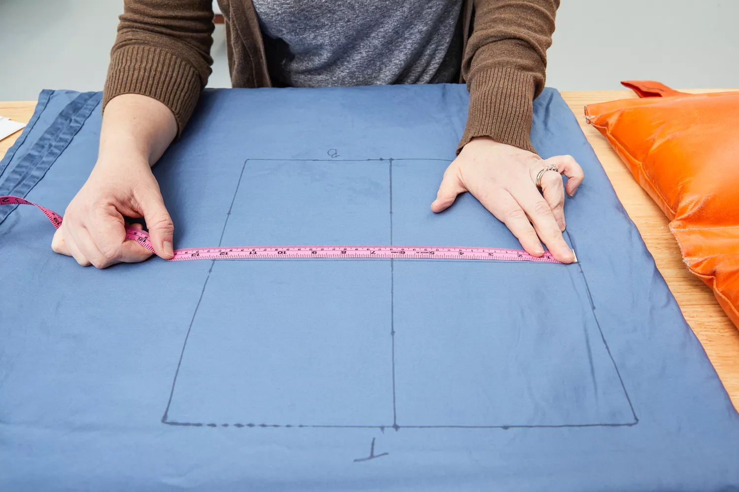person measures section of Better Homes & Gardens 400 Thread Count Hygro Cotton Bed Sheet